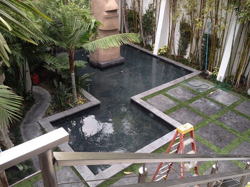 Courtyard pool and water feature with stone pavers and bamboo planting