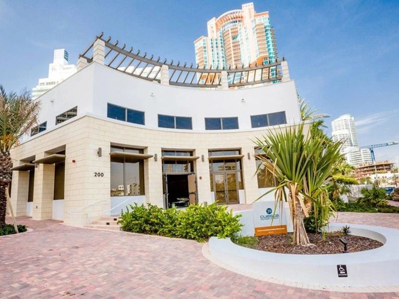 Modern white commercial building with pergola roof structure, South Beach