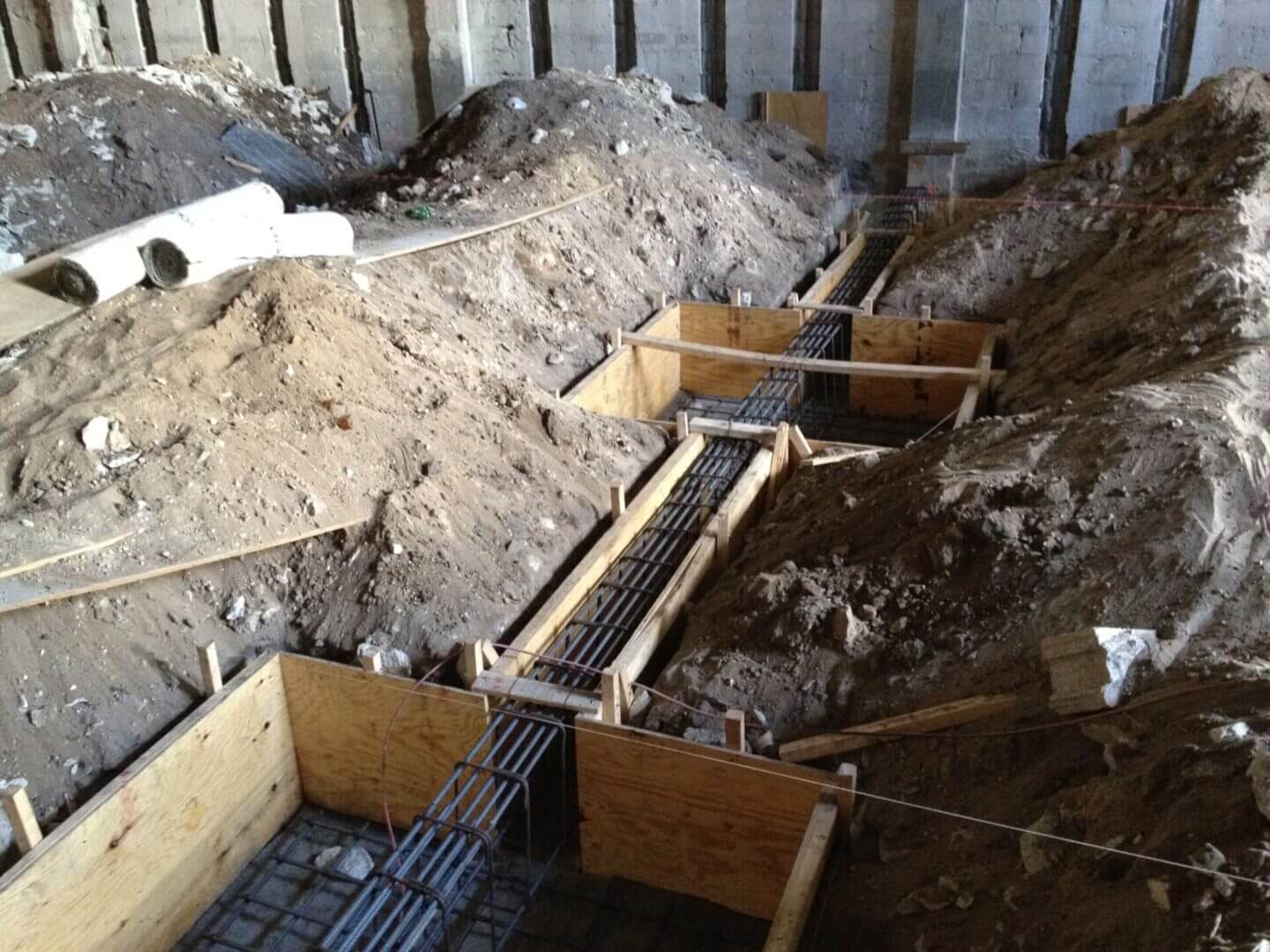 Formwork and rebar for new footings excavated inside an existing structure