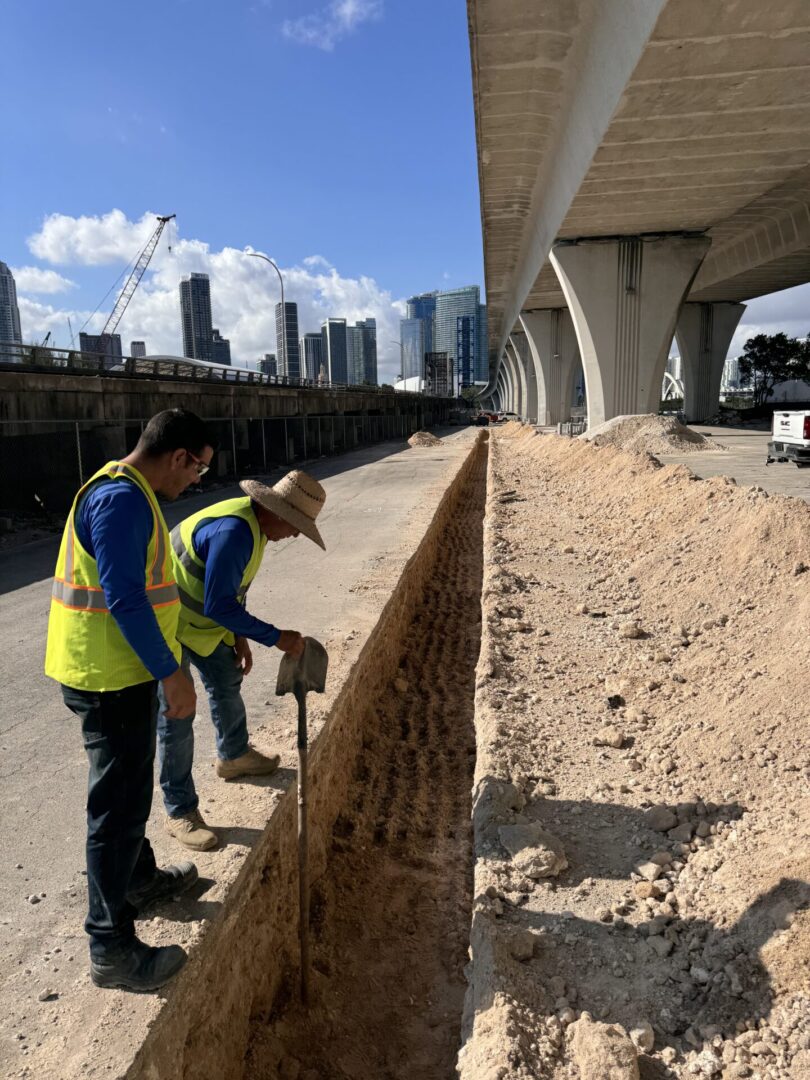 Excavation for underground utilities beneath an elevated roadway in downtown Miami