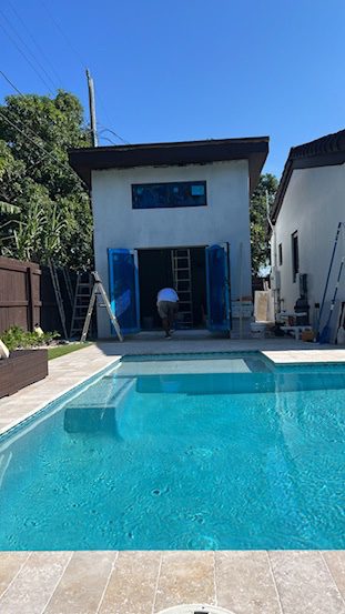 Accessory structure under construction beside a residential pool