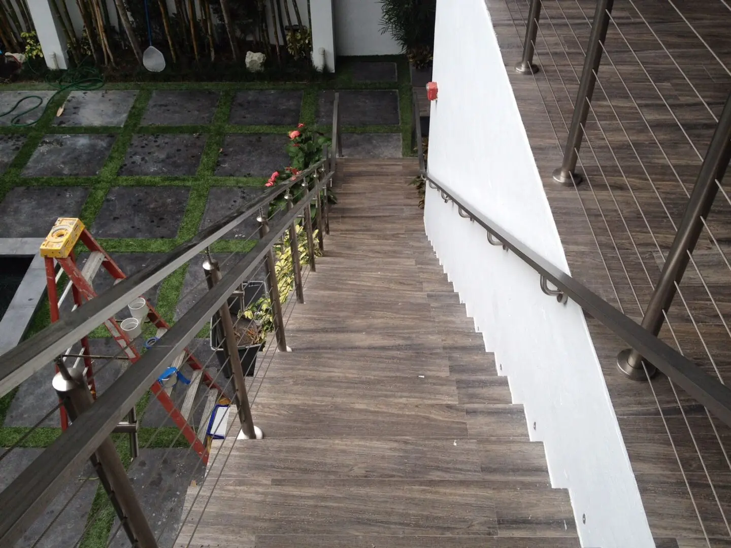 A wooden staircase with metal railing and steps.